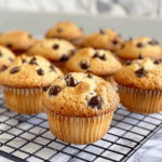 Gluten-free chocolate chip muffins cooling on a black wire rack