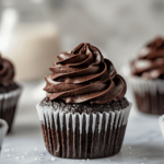 Gluten-free chocolate cupcake with rich chocolate frosting in a white paper liner